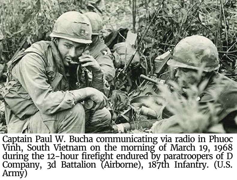 Captain Paul W. Bucha communicating via radio in Phuoc Vinh
